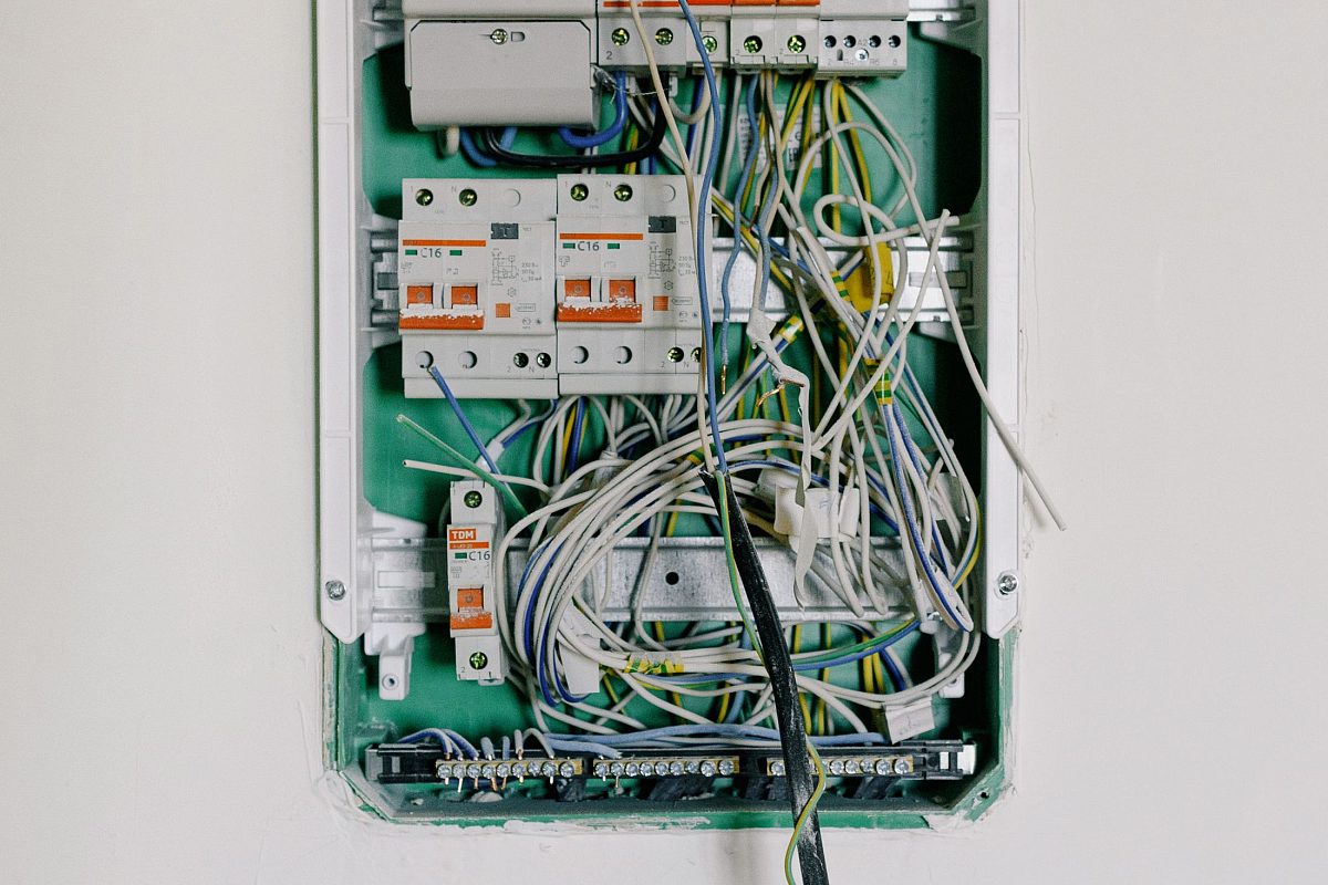 Opened accessory showing wiring being checked and reterminated