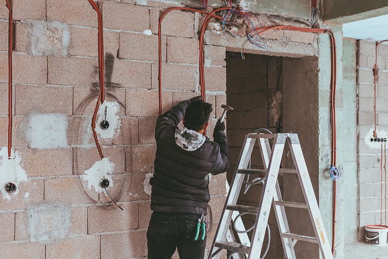 Electrician working on a domestic installation during a home visit