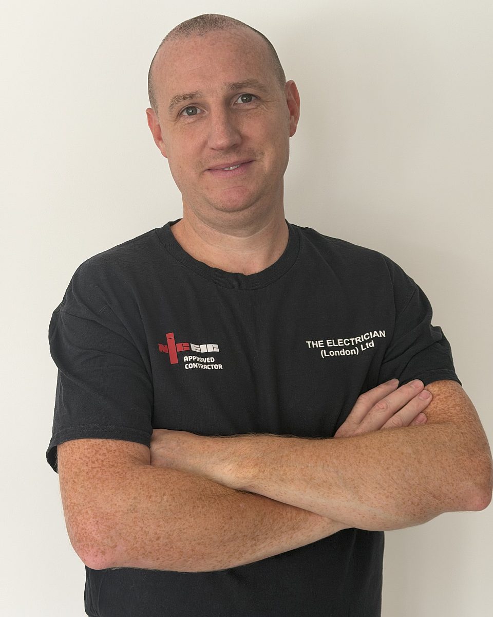Phil Boon, managing director, in a company T-shirt with the NICEIC Approved Contractor logo